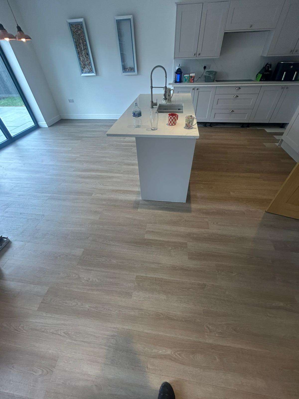 Wood-effect laminate flooring installed in a Norfolk home by Compass Flooring